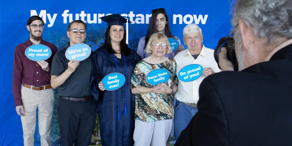 A family with World Campus graduate in cap and gown