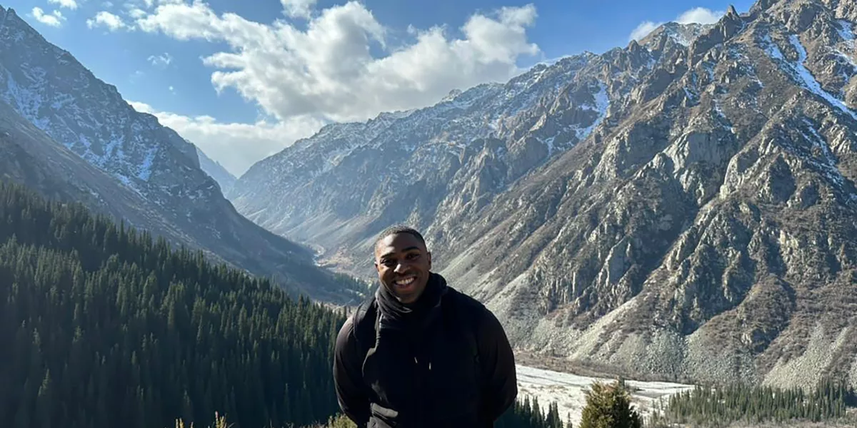 Denzell Ivery in front of scenic rock mountains