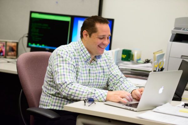 Alumni Ambassador working at his laptop