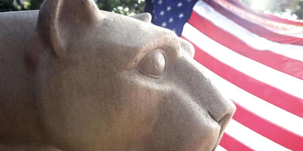 Nittany Lion Shrine in front of American flag.