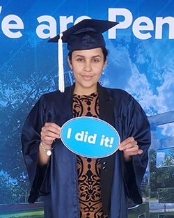 Melissa holding an "I did it!" sign.