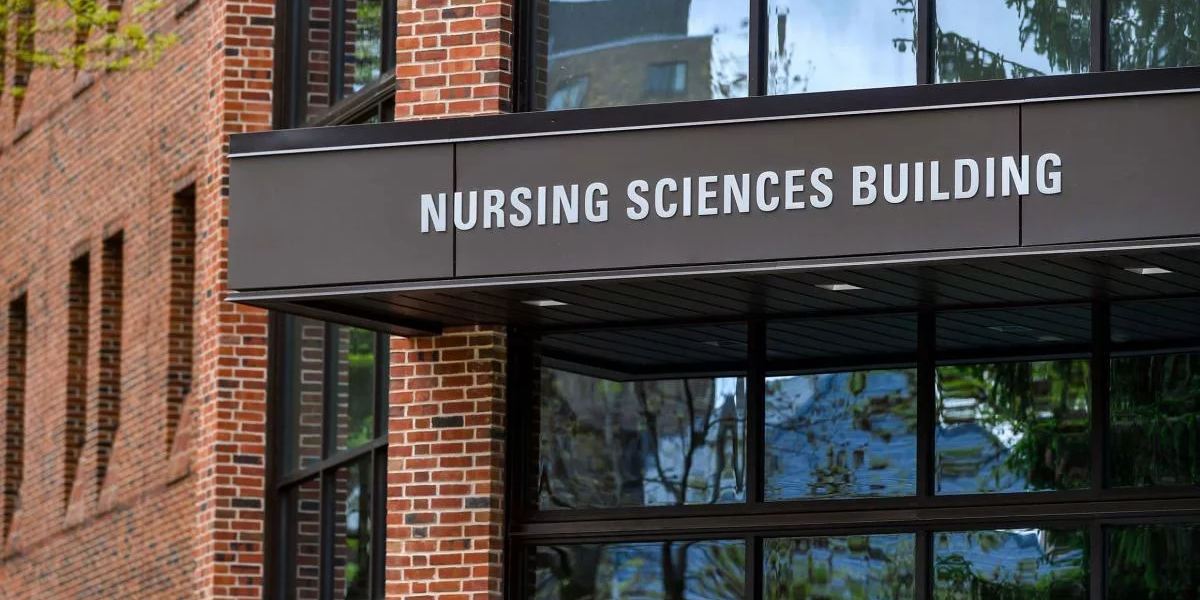 The words of the Nursing Sciences Building are shown on an awning hanging over the entrance.