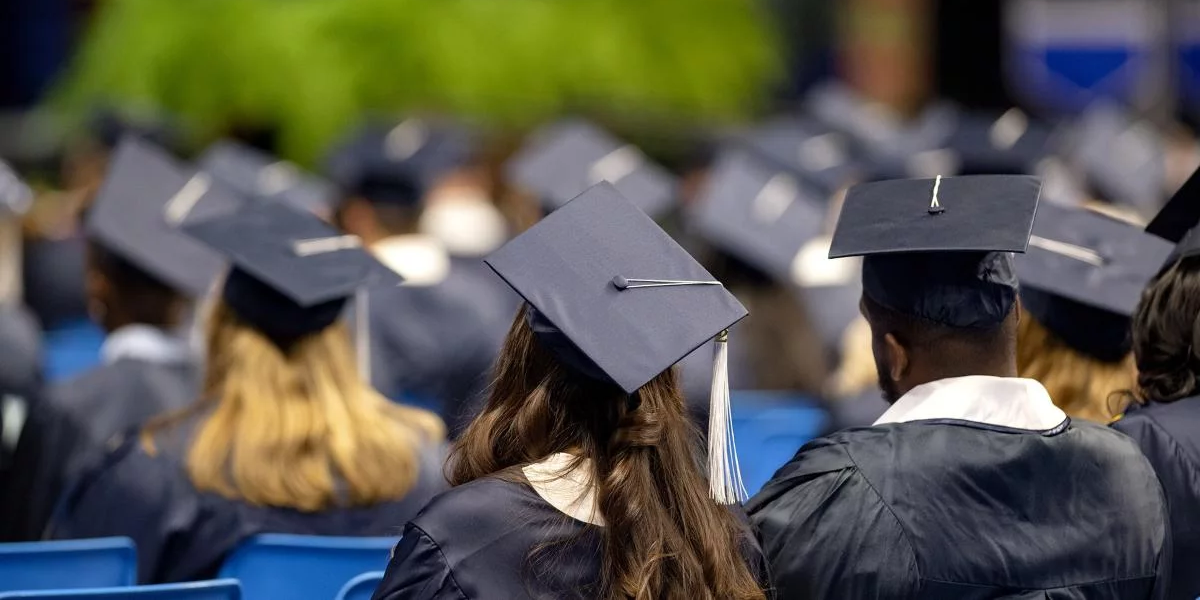 Students in caps and gowns from behind