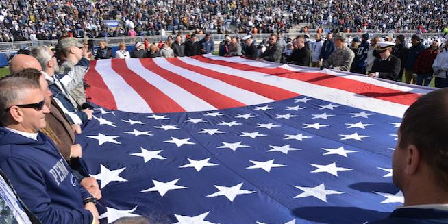 US flag held by active and veterans at Beaver Stadium
