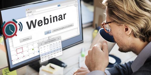 Person drinking coffee and watching a webinar