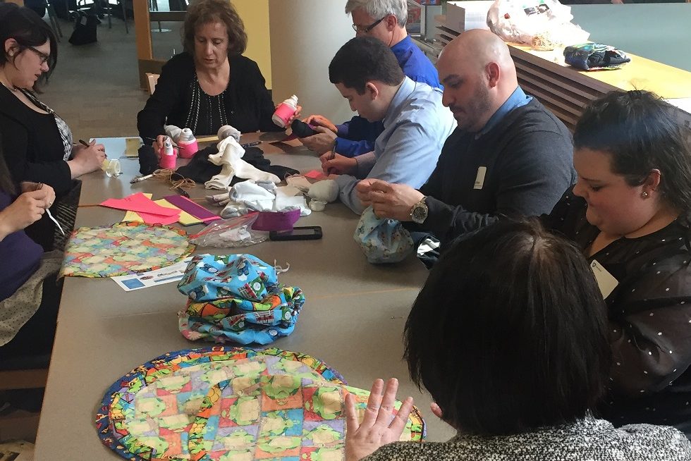 Group of people assembling care kits at a table