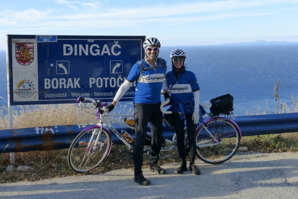 Tom Fritz and Christy Grim standing next to bikes at an overlook